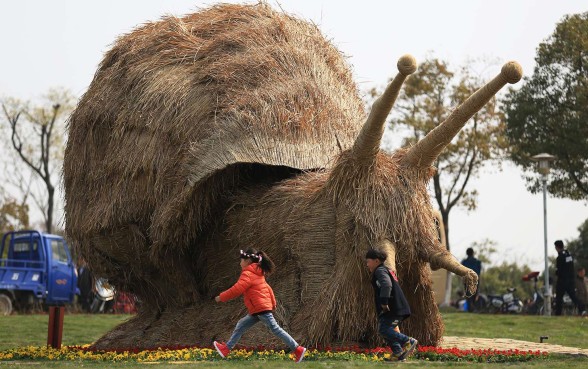 Snail pace - Children run near a giant snail made of straw at a tourism festival in Nanjing, capital of Jiangsu province. Nanjing is popular with tourists and considered to be one of the mainland’s most beautiful cities with many parks and lakes as well as historical buildings and monuments. Photo: Xinhua Snail pace - Children run near a giant snail made of straw at a tourism festival in Nanjing, capital of Jiangsu province. Nanjing is popular with tourists and considered to be one of the mainland’s most beautiful cities with many parks and lakes as well as historical buildings and monuments. Photo: Xinhua