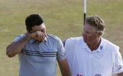 Jason Day walks off the 18th green with his caddie, Colin Swatton, after the third round at Chambers Bay in University Place, Washington. Photo: AP