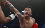 China's double Olympic gold medalist Zou Shiming, right, and Thailand's Amnat Ruenroeng exchange punches during their IBF flyweight title belt boxing match at the Venetian Macao in Macau, Saturday, March 7, 2015. Ruenroeng won the IBF flyweight title belt boxing match. (AP Photo/Kin Cheung)