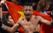 Zou Shiming of China celebrates after winning against Natan Coutinho of Brazil in their WBO international flyweight boxing title bout in Shanghai on January 30, 2016. AFP PHOTO / JOHANNES EISELE