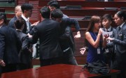 Baggio Leung (left) is held back as his Youngspiration colleague Yau Wai-ching makes a vain attempt to retake the oath of office. Photo: Felix Wong