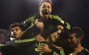 Mexico forward Javier Hernandez (14) jumps onto teammates following Mexico's second goal against the USA at MAPFRE Stadium. Joe Maiorana-USA TODAY Sports