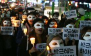 South Korean university students march with candlelight and placards demanding President Park Geun-Hye step down during a protest in Seoul this week. Photo: EPA
