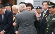 Former Hong Kong chief executive Tung Chee-hwa giving Chief Secretary Carrie Lam a hug during a ceremony to commemorate the Nanjing massacre on Tuesday. Photo: K. Y. Cheng