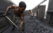Workers unload coal at a storage site along a railway station in Hefei, Anhui province, China. Photo: Reuters