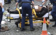 Press Association news agency photos believed to be of the knifeman lying on an ambulance stretcher showed a burly man with black clothes and a beard. Photo: PA