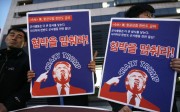 South Korean protesters hold images of US President Donald Trump during a rally denouncing the United States' policy against North Korea near the US. Embassy in Seoul on Wednesday. Photo: AP South Korean protesters hold images of US President Donald Trump during a rally denouncing the United States' policy against North Korea near the US. Embassy in Seoul on Wednesday. Photo: AP