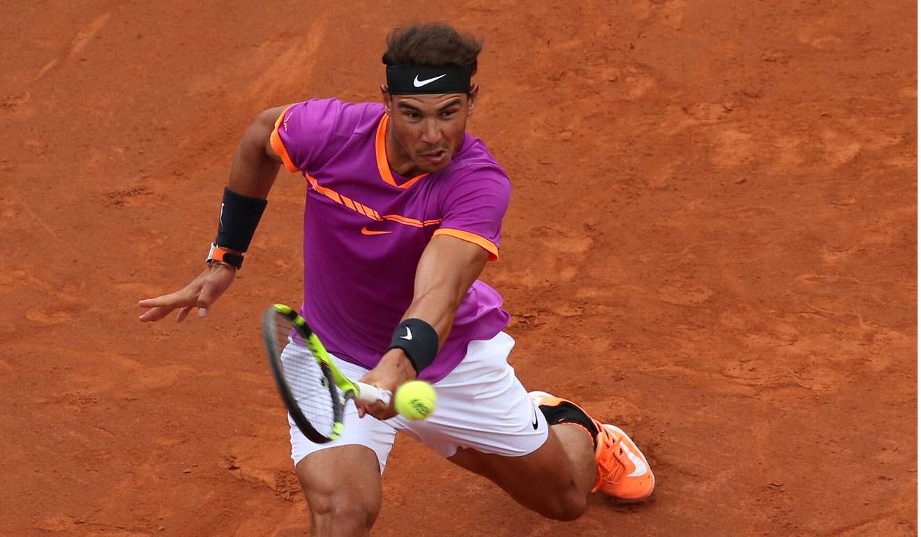Rafael Nadal returns to Dominic Thiem. Photo: Reuters