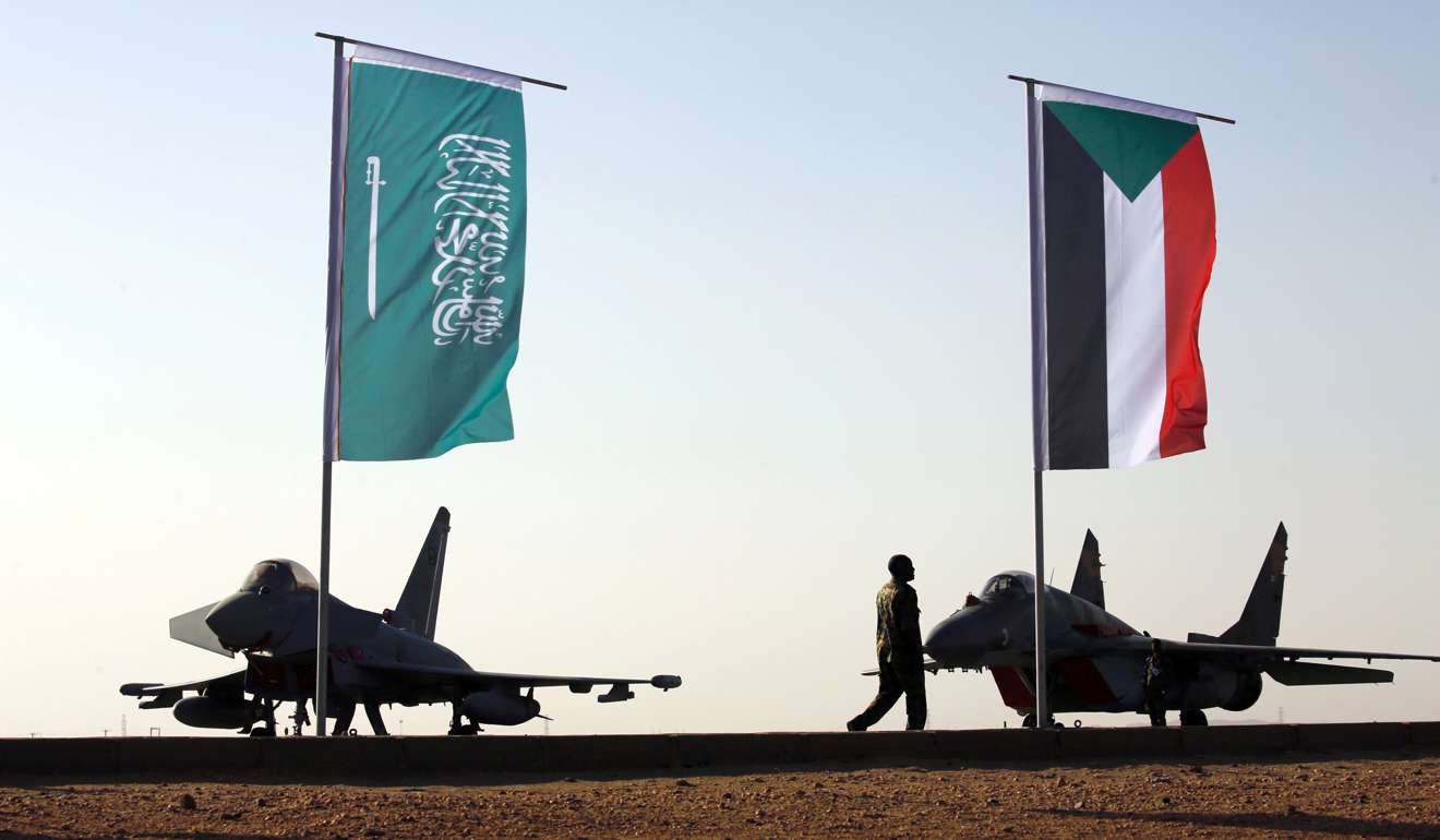 Military personnel walk past the flags of Saudi Arabia and Sudan at the final training exercise last month between the Saudi Air Force and Sudanese Air Forces at Merowe Airport in Merowe, Northern State, Sudan. In the past decade, increases in Saudi defence spending have been almost 40 times faster than growth in per capita incomes. Photo: Reuters