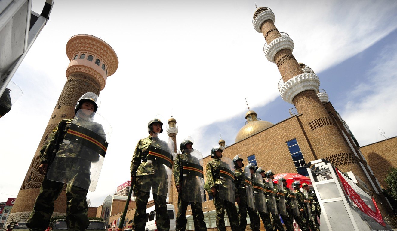 Chinese paramilitary police guard the outside of the Grand Bazaar in Urumqi following riots in July, 2009. Photo: AFP