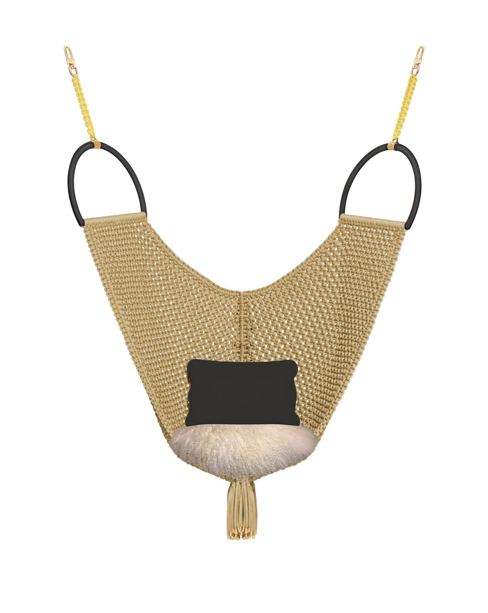 Kick back and relax in this handbag-inspired swinging chair which features two large leather-covered metallic handles and a woven mesh. Price on request