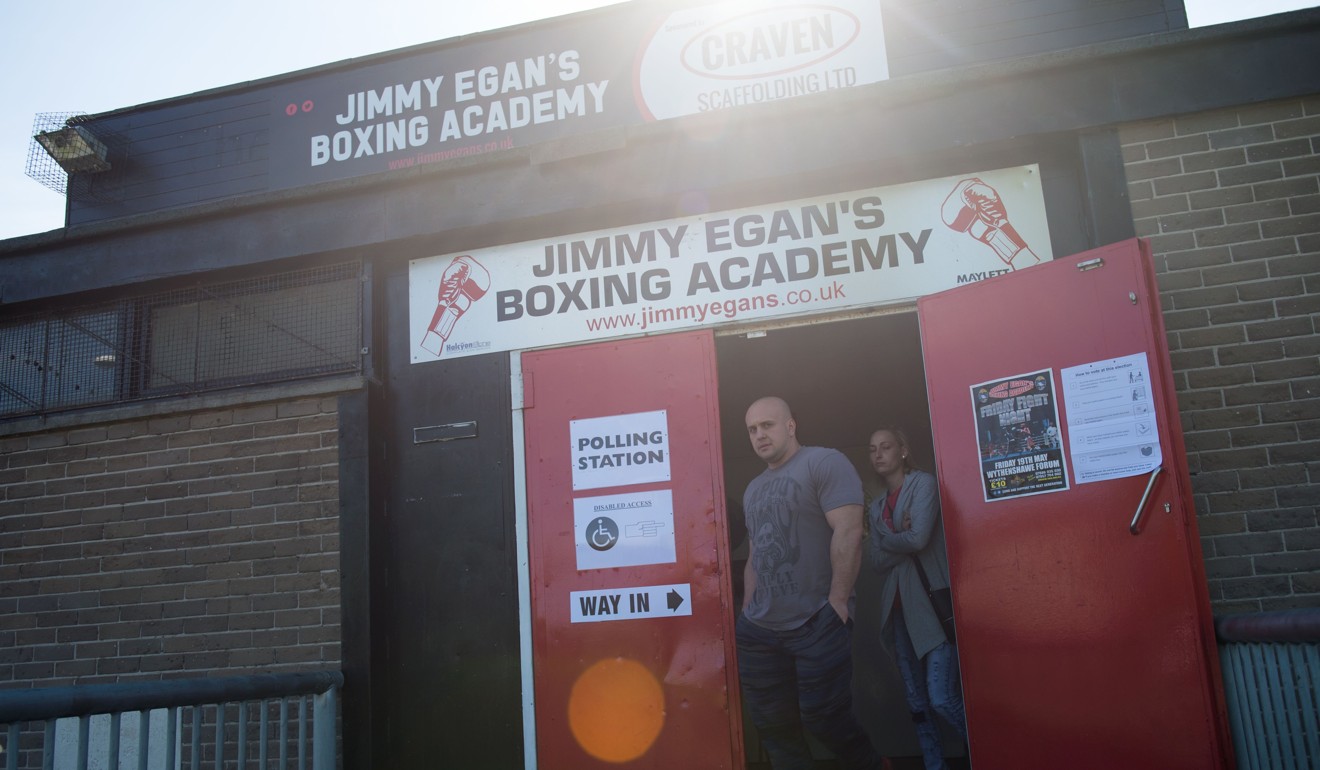 Voters leave a polling station in Jimmy Egan's Boxing Academy, Manchester, northern England. Photo: AFP