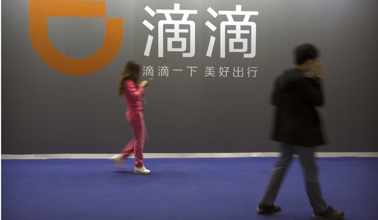 Visitors walk past a sign for Chinese ride-hailing service Didi Chuxing at the Global Mobile Internet Conference in Beijing last week. The conference features current and future trends in the mobile internet industry by some major foreign and Chinese internet companies. Hong Kong’s leaders have failed to alert people to the far-reaching implications of China’s economic ascendency. Photo: AP