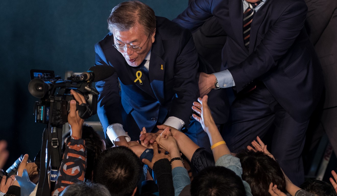 Moon Jae-in, president-elect of South Korea, shakes hands with attendees during a celebration at Gwanghwamun Square in Seoul, South Korea, on Tuesday, May 9, 2017. Jae-in declared victory in South Korea's leadership race, pledging to unify the nation after nine years of conservative rule. Photo: Bloomberg