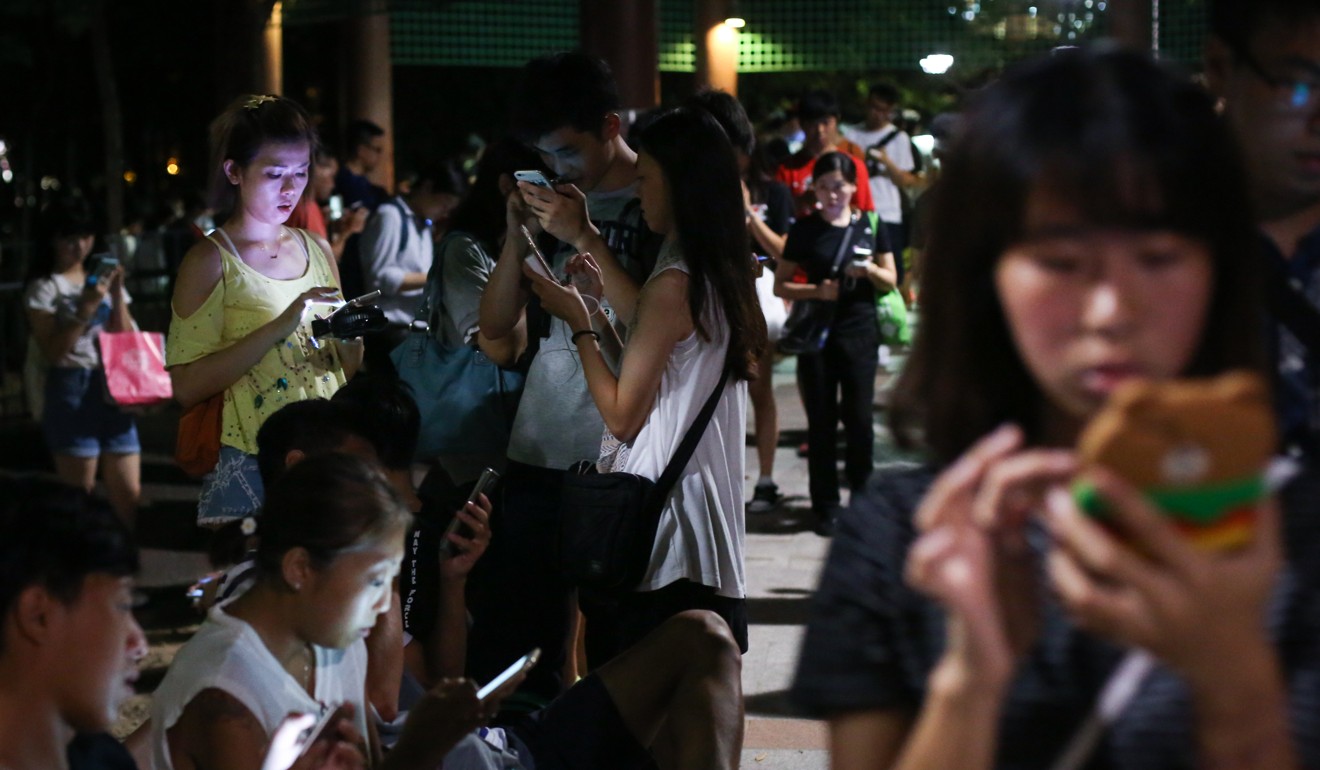 Young people gather to play the mobile phone game “Pokemon Go” in Tuen Mun in July last year. Social media is ubiquitous in teen lives. According to research, about 20 per cent of Hong Kong’s young people are vulnerable to risky behaviour, but do not seek help from existing social services. They turn to friends and social media instead. Photo: Sam Tsang