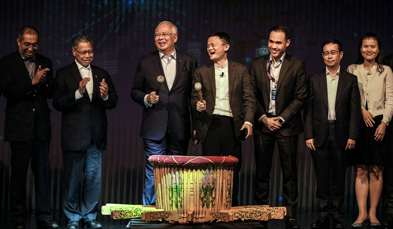 Malaysian Prime Minister Najib Razak (third from left) and China’s Alibaba Group founder Jack Ma (fourth from right) smile after hitting a gong during the launch of Malaysia’s “Digital Free Trade Zone” in Kuala Lumpur in March. Photo: AFP