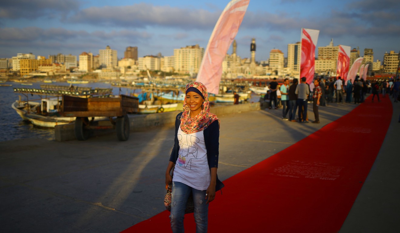 A Palestinian woman walking on the red carpet during a festival showcasing films focusing on human rights in Gaza City on May 12, 2017. Photo: AFP