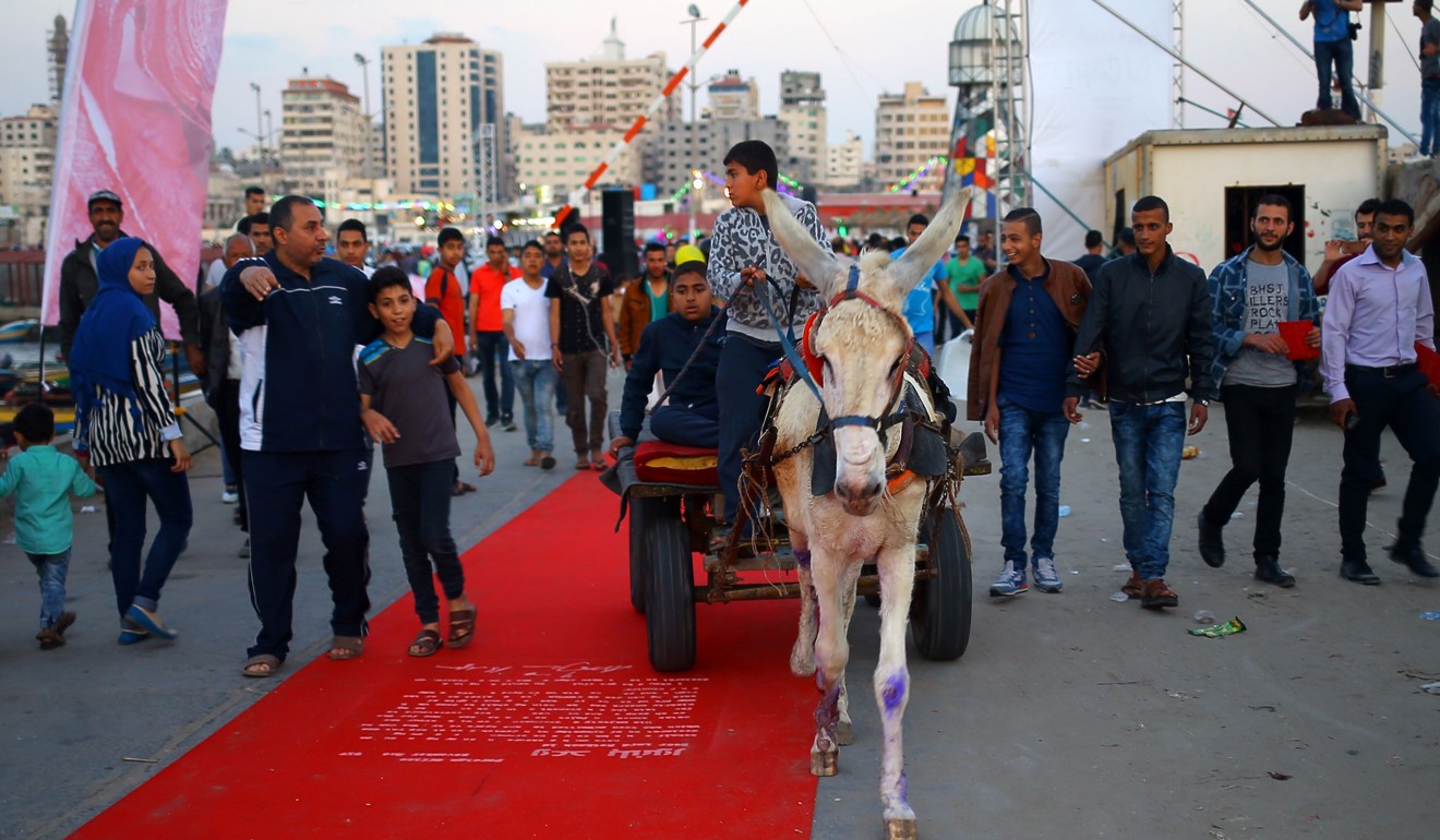 A Palestinian leads a donkey-kart on the red carpet: Photo: AFP