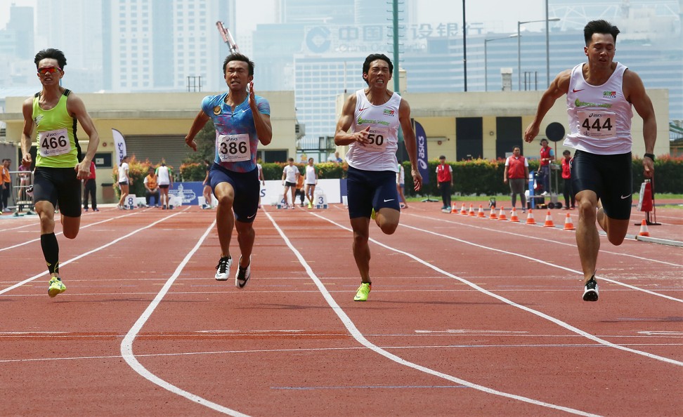 Ng Ka-fung (right) on his way to winning the men’s 100m final. Photo: Jonathan Wong