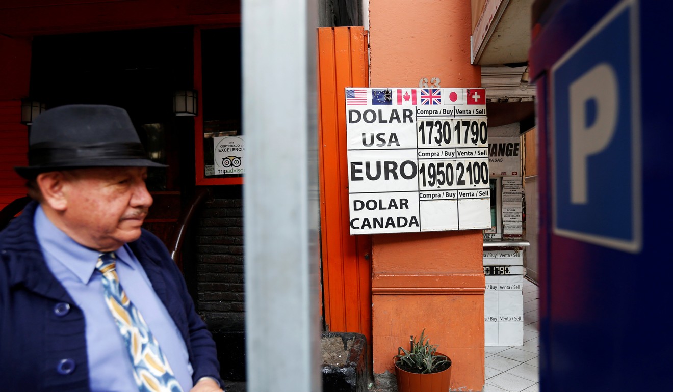 A man stands next to a board displaying the exchange rate of the Mexican peso against the US dollar. The greenback had its worst trading week due to the political problems of US President Donald Trump. Photo: Reuters
