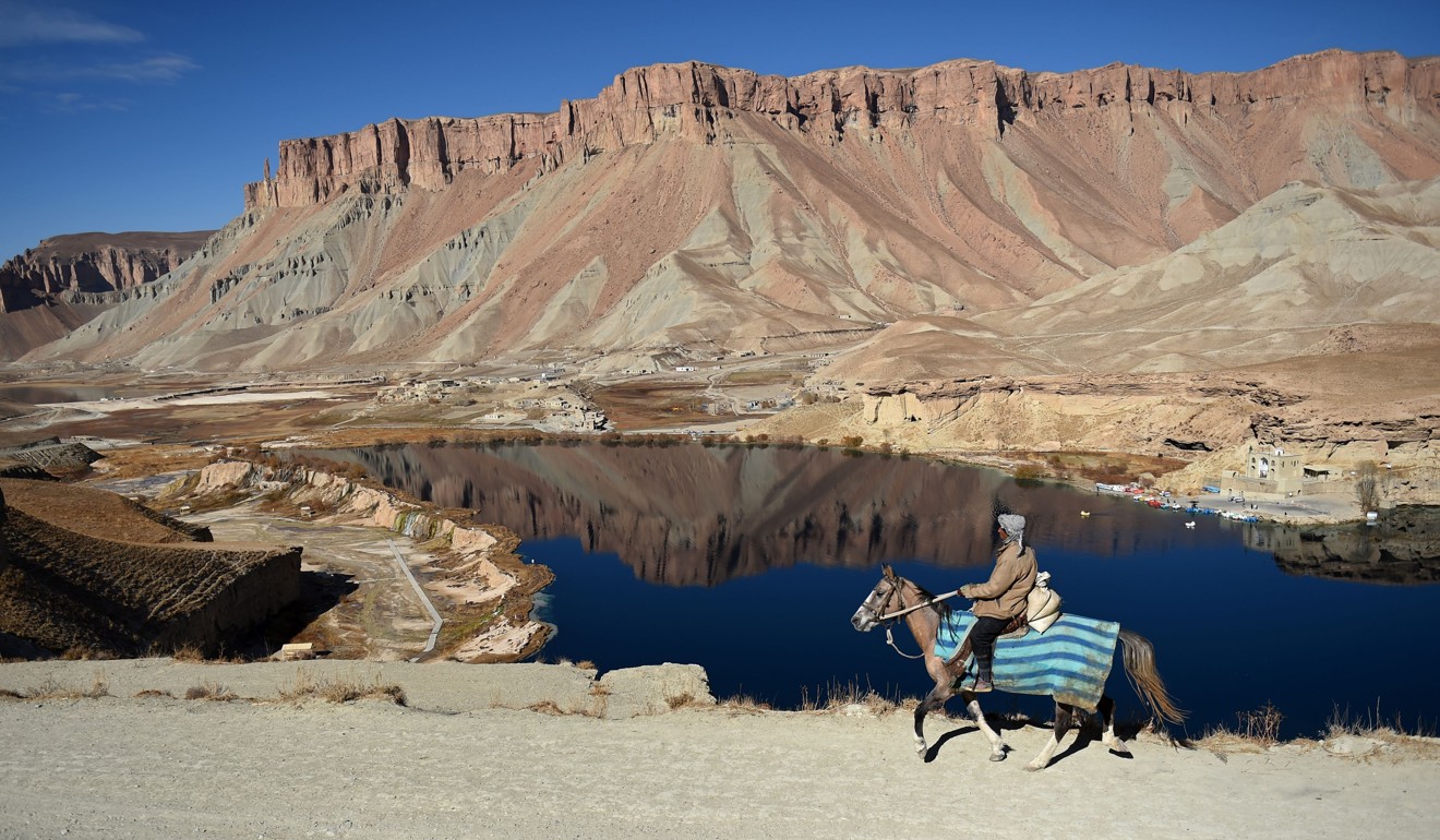 An Afghan man riding a horse overlooking Band-e-Amir lake on the route of the ancient Silk Road to China. Photo: AFP