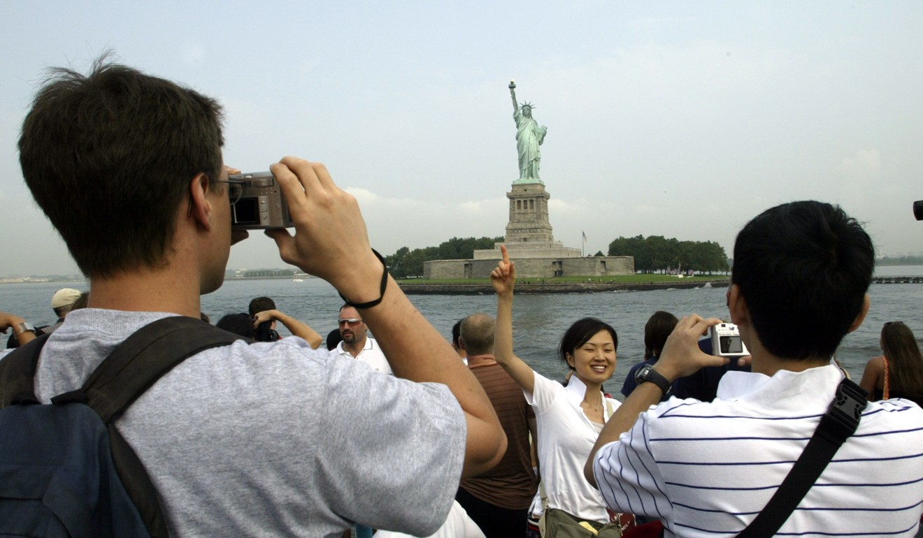 Asian tourists take in the sights in New York. Photo: AFP