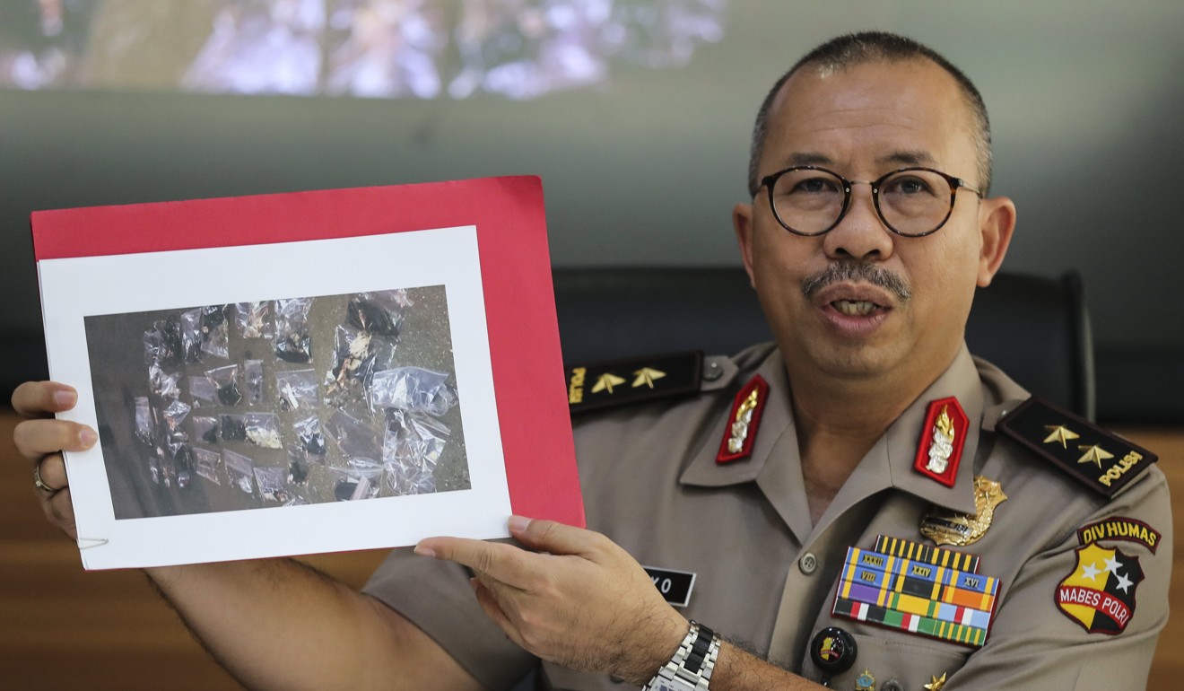 Police spokesperson Setyo Wasisto shows a picture of evidence collected from the bomb blast site. Photo: EPA