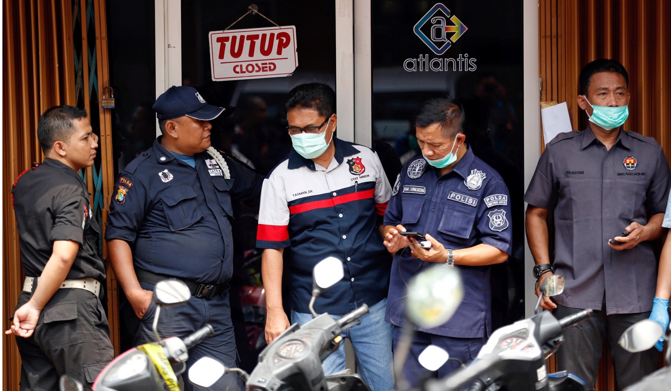 Police and security are seen outside the club where police detained 141 men for what they described as a pornography ring in Jakarta, Indonesia. Photo: Reuters