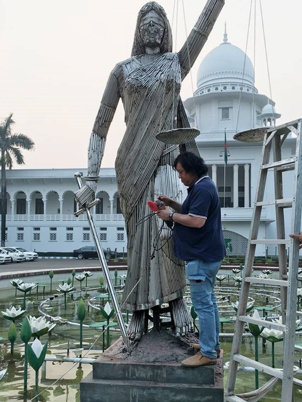 Sculptor Mrinal Haque works on his lady justice statue outside the Supreme Court in Dhaka. Photo: Facebook / Mrinal Haque
