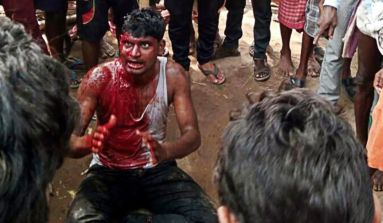 A bloodied man pleads for his life while surrounded by a mob in Jharkhand state in eastern India. Photo: Hindustan Times