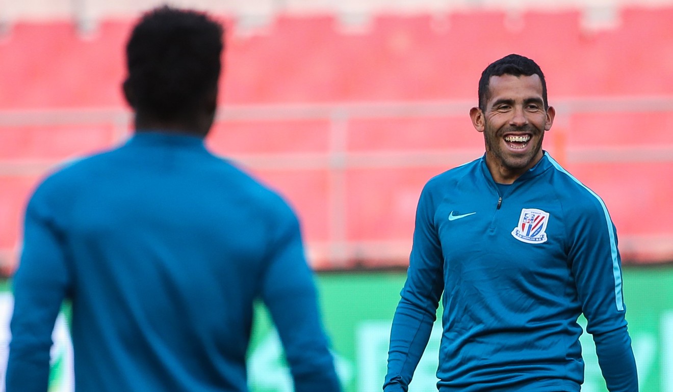 Argentinian player Carlos Tevez (R) of Shanghai Shenhua during a training session at the Workers Stadium in Beijing. Photo: EPA
