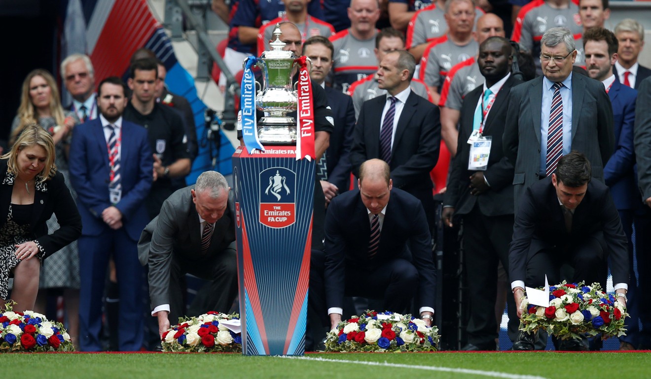 Britain’s Prince William, in his role as president of the English Football Association, and Andy Burnham (right), mayor of Greater Manchester, lay wreaths in memory of the victims of the Manchester attack before the FA Cup final at London’s Wembley Stadium, on May 27. Photo: Reuters
