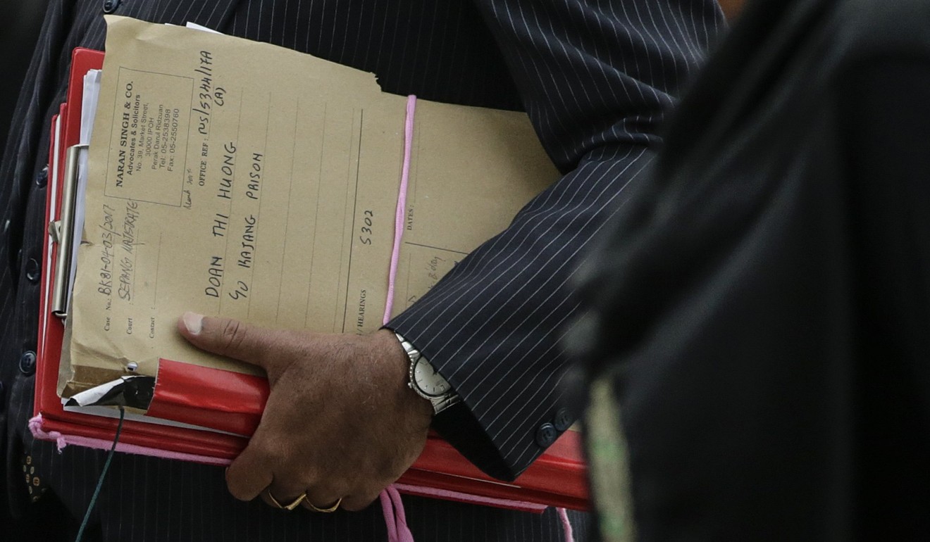 A lawyer of Vietnamese Doan Thi Huong, one of the two suspects detained in connection with the death of Kim Jong-nam, is seen holding documents. Photo: EPA