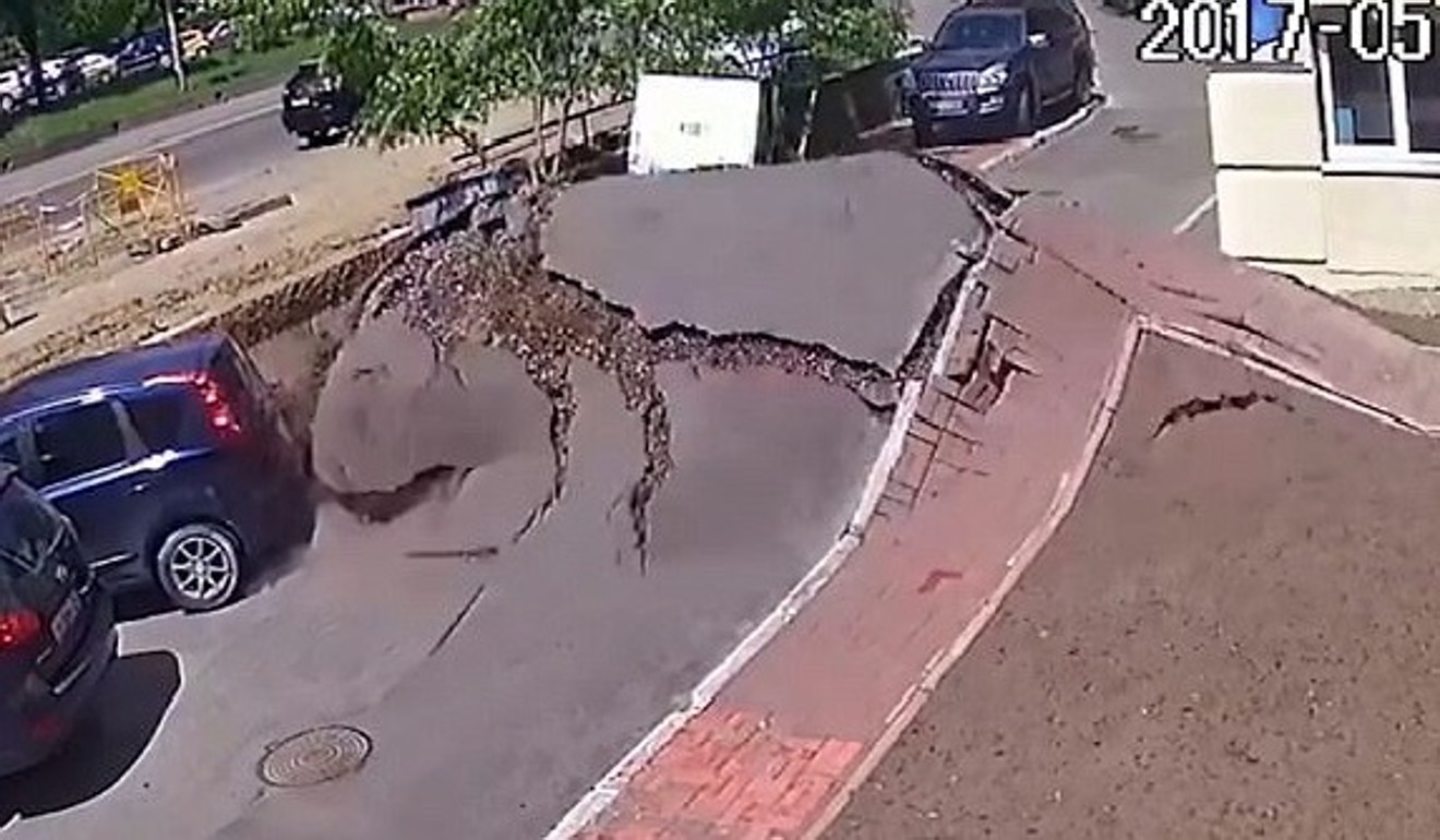 The surface of a carpark in Kiev, Ukraine, begins to balloon under the pressure of a burst water main on Monday. moments before a massive explosion. Photo: YouTube/Live Leak