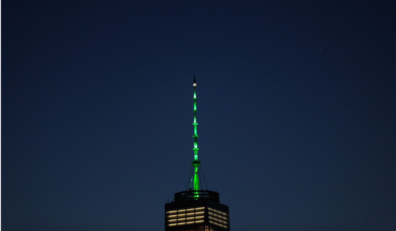 One World Trade Centre in New York is lit green in response to President Donald Trump’s decision to pull the United States out of the Paris Climate Accord. Despite the Trump administration, major American actors will likely push ahead with climate change commitments. Photo: AFP