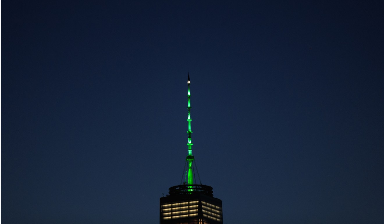 One World Trade Centre in New York is lit green in response to President Donald Trump’s decision to pull the United States out of the Paris Climate Accord. Despite the Trump administration, major American actors will likely push ahead with climate change commitments. Photo: AFP