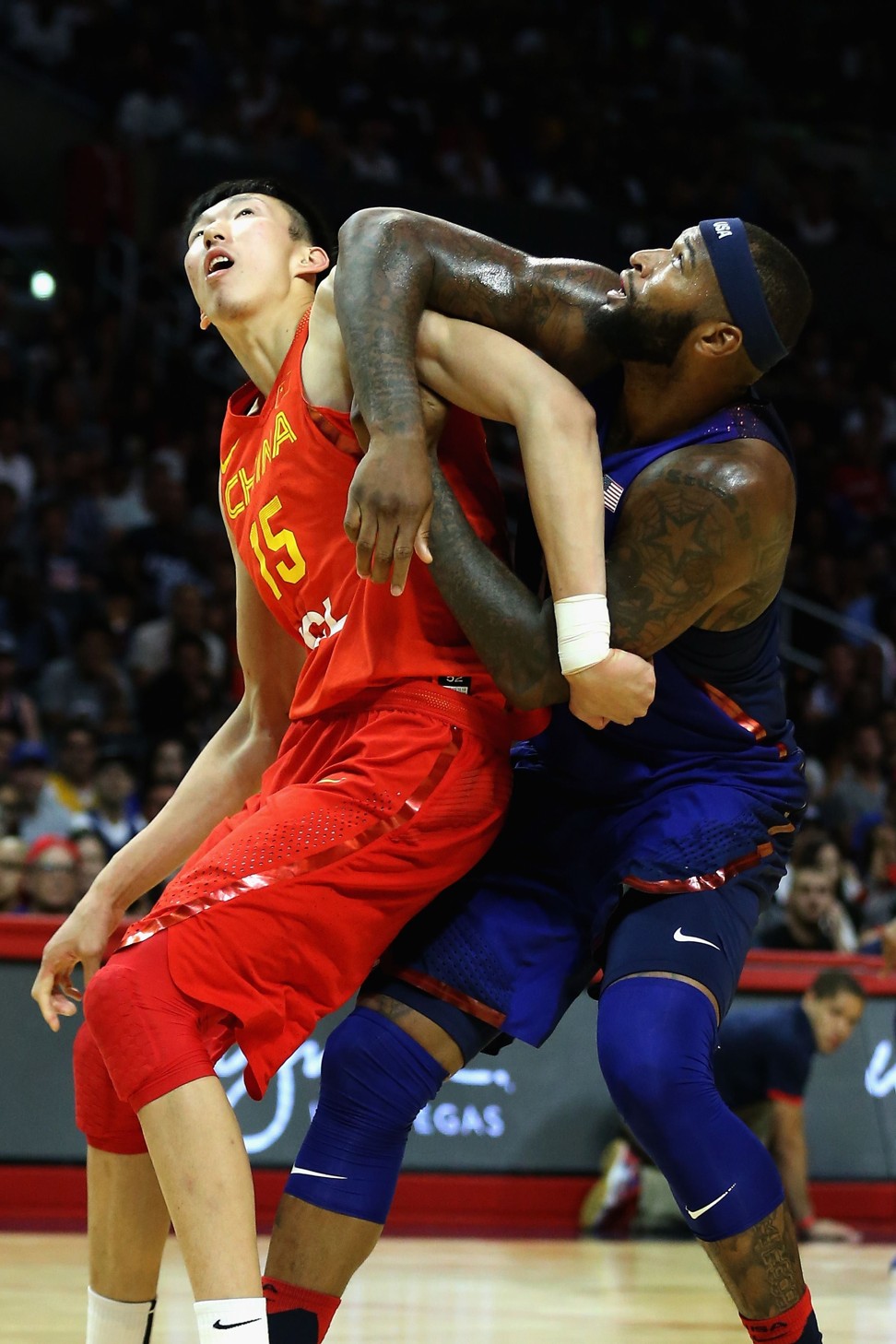 China’s Zhou Qi, pictured tangling with DeMarcus Cousins during an exhibition game, is bound for the NBA. Photo: AFP