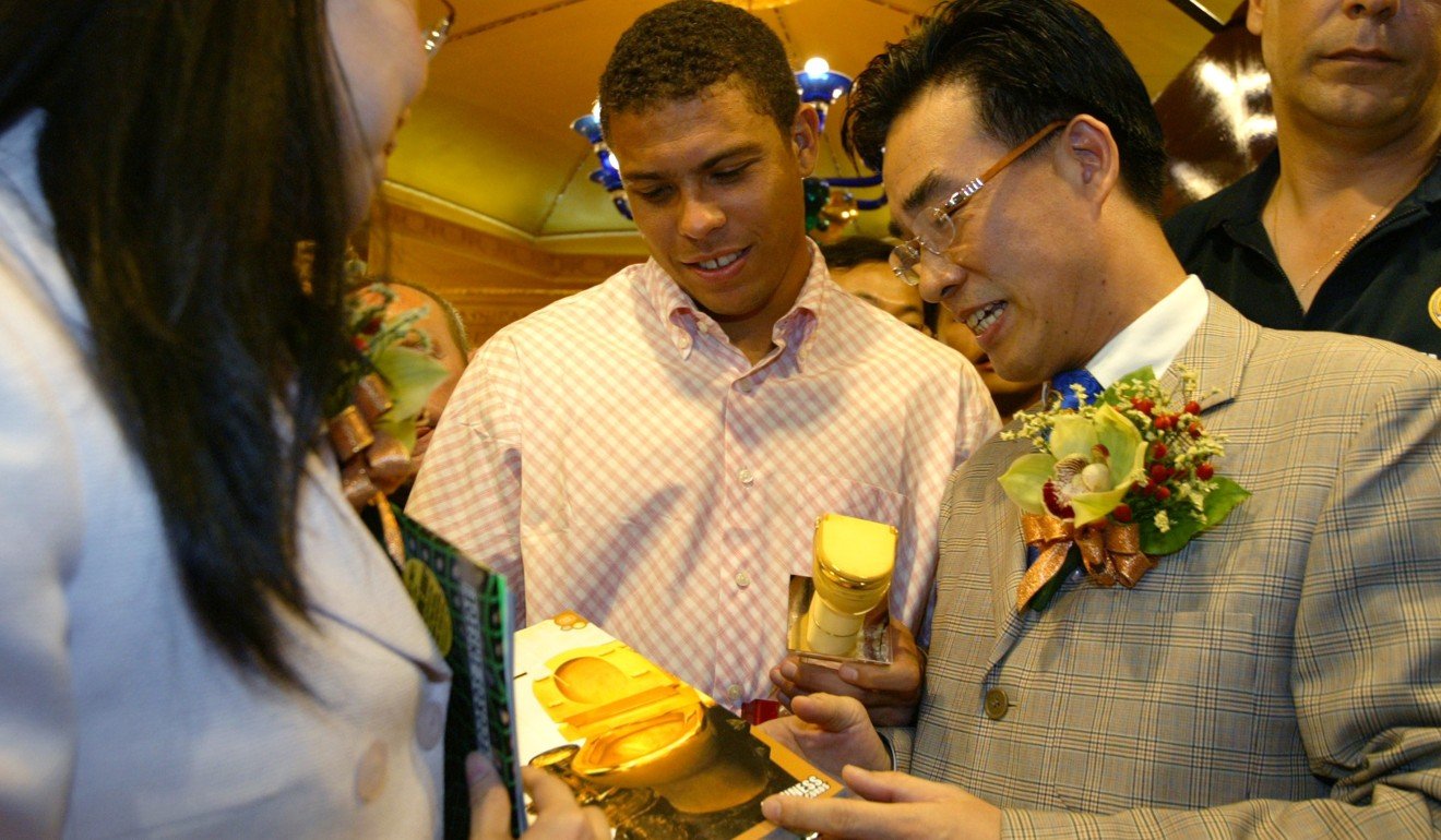 Ronaldo is presented with a souvenir gold mini-toilet in Hung Hom in August 2003. Photo: Robert Ng