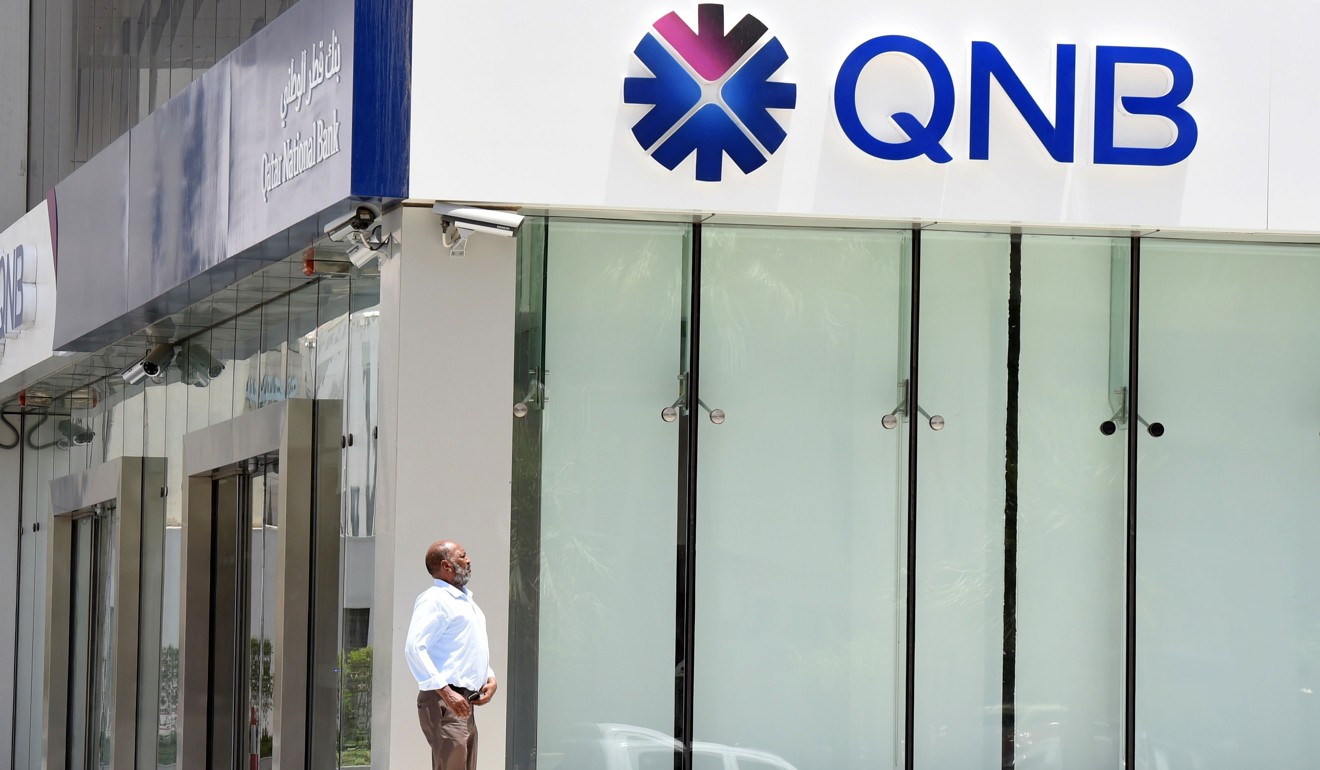 A man walks past the Qatar National Bank branch in the Saudi capital Riyadh, following a severing of relations between major gulf states and gas-rich Qatar. Photo: AFP