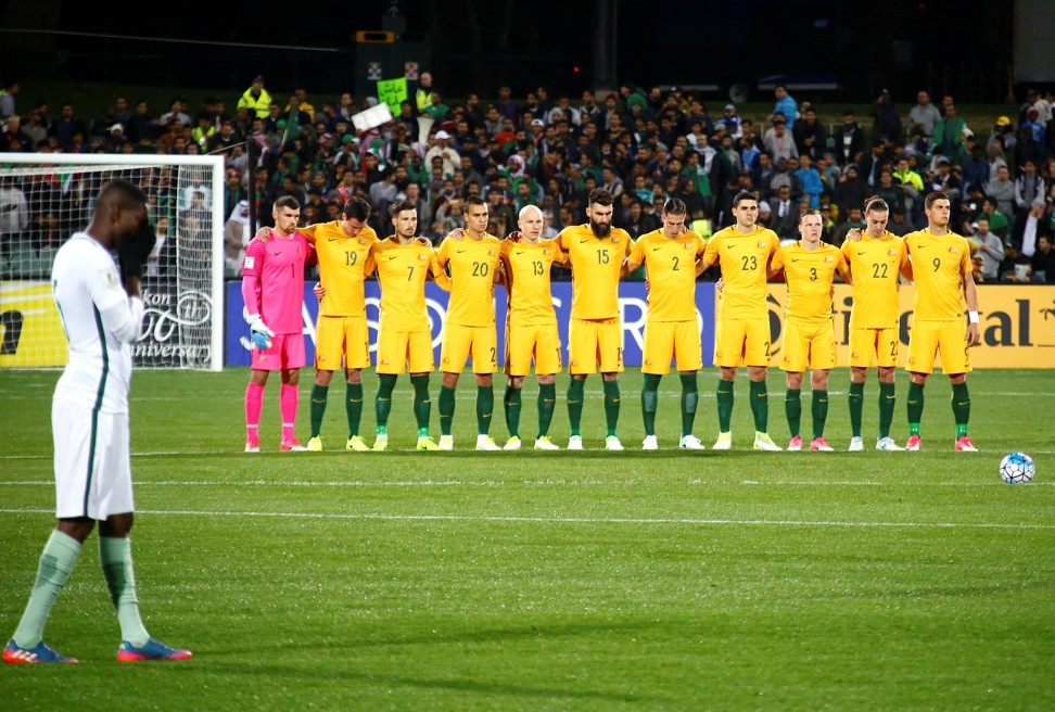 The Australian team stand together as they observe a minute’s silence for victims of the London attacks. Photo: Reuters