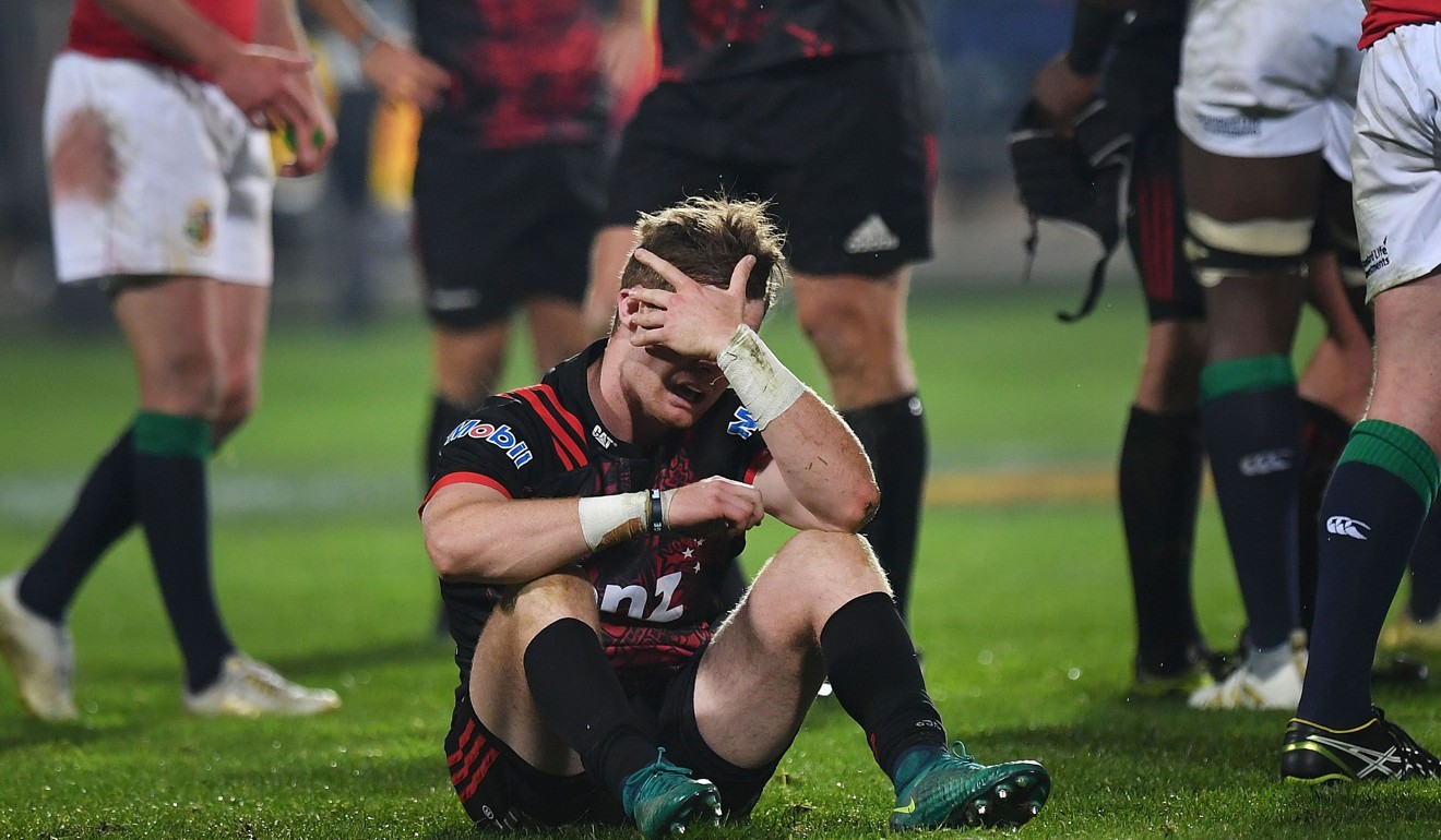 The Crusaders’ Mitchell Drummond sits dejected after their loss to British & Irish Lions. Photo: AFP
