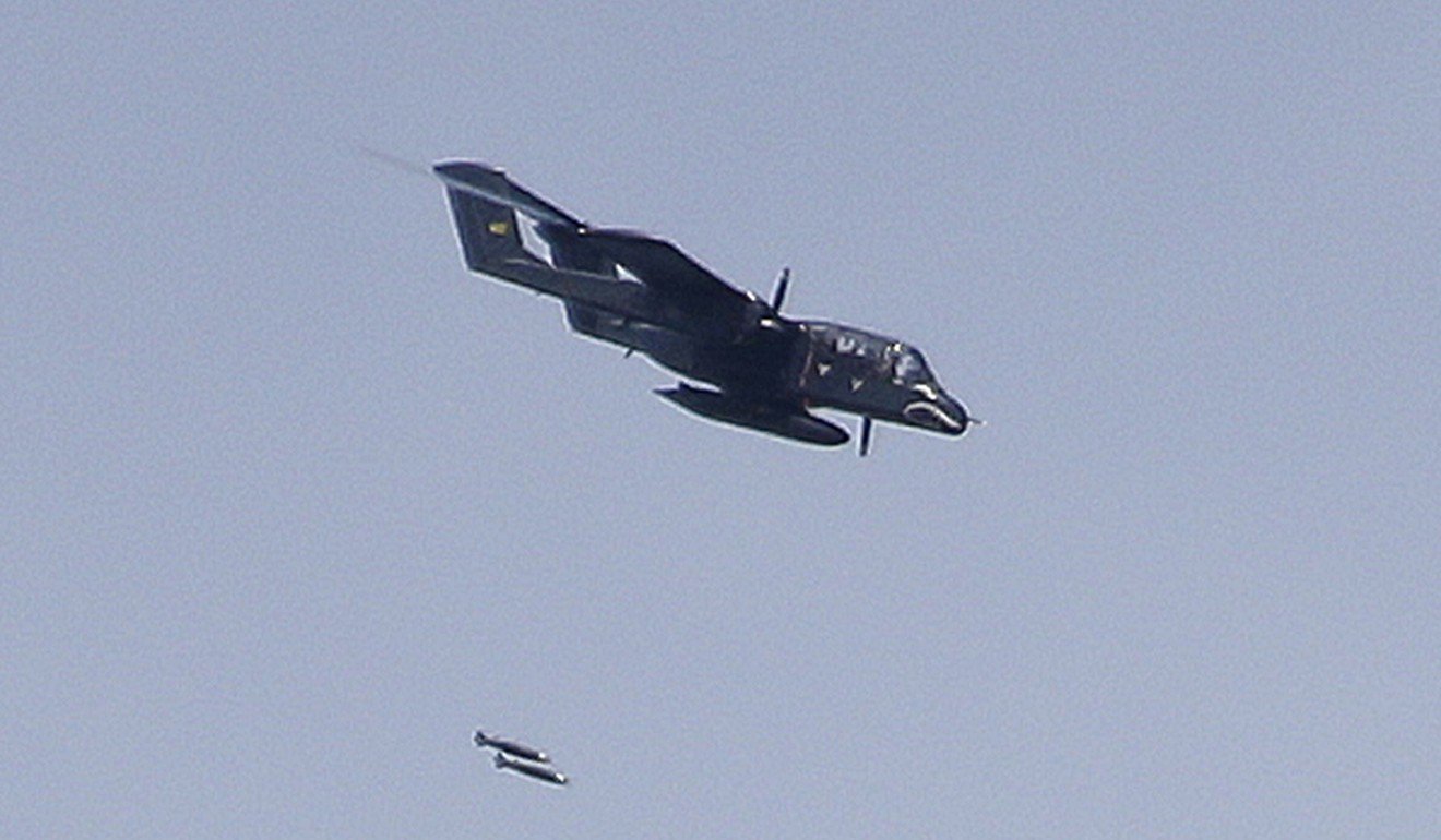 A Philippine Air Force OV-10 Bronco drops bombs on suspected positions of Muslim militants. Photo: AP