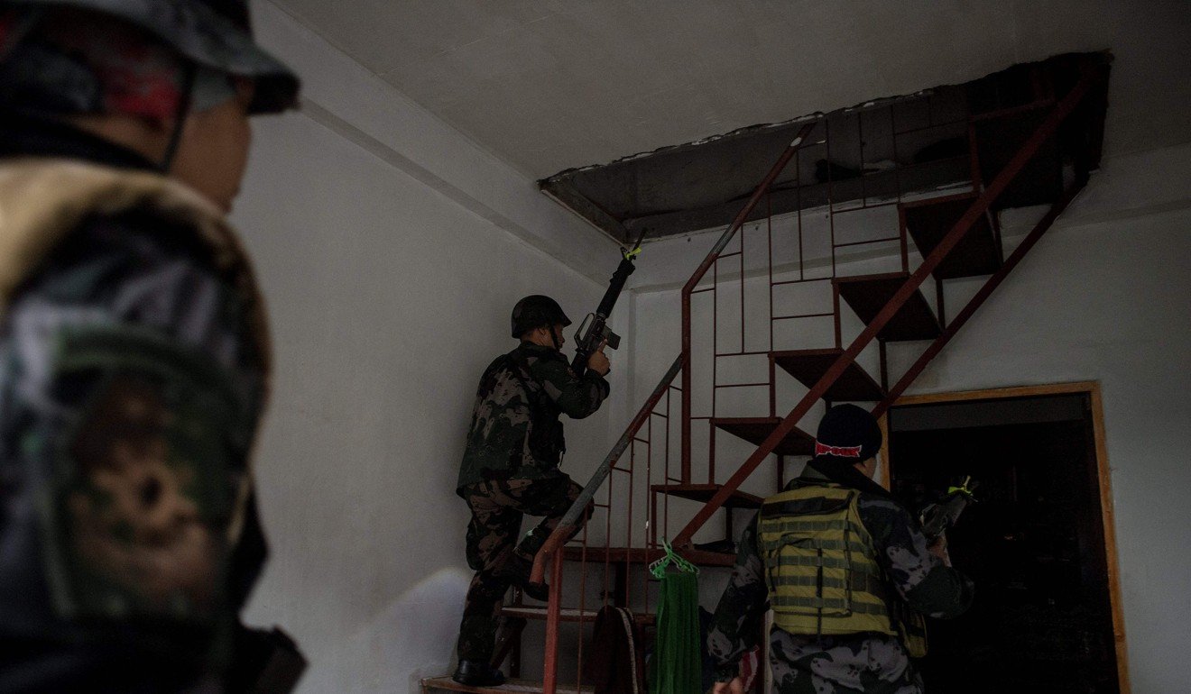 Security forces search a house in Marawi. Photo: AFP