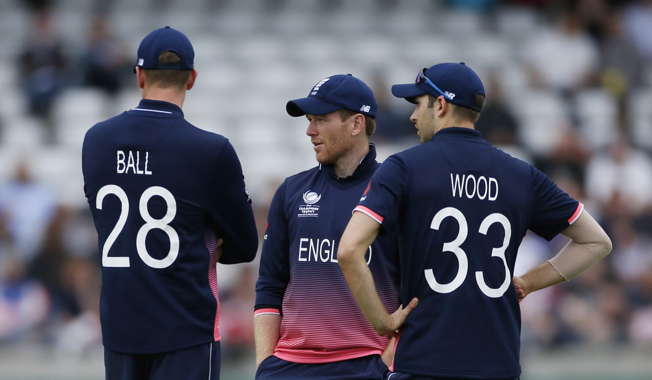 England captain Eoin Morgan talks to bowlers Jake Ball and Mark Wood.