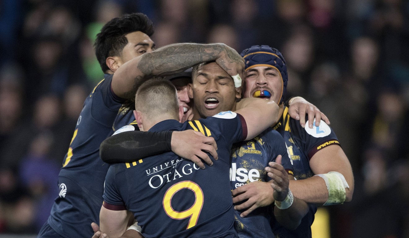 Highlanders winger Waisake Naholo is congratulated by teammates after scoring a try against the British & Irish Lions in Dunedin. Photo: AP