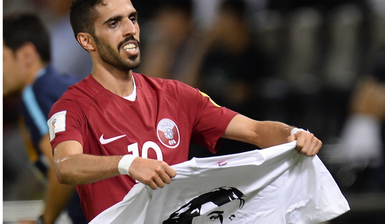 Hasan Al Haydos of Qatar celebrates with a T-shirt portrait of Emir Sheikh Tamim bin Hamad Al-Thani after scoring a goal against South Korea. Photo: EPA