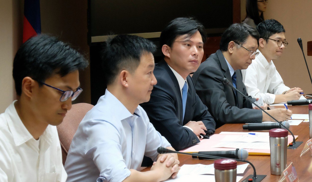 Hong Kong fringe party members and Legislative Council members Eddie Chu, left, Raymond Chan, second from left, and Nathan Law, right, sit with Taiwan legislator Huang Kuo-chang, centre, and Secretary General of Taiwan's parliament Lin Yu-chia, second from right, at the Parliament in Taipei. Lawmakers in Taiwan launched a new group to help promote democracy in Hong Kong, a move likely to rile Beijing ahead of the 20th anniversary of the handover of the city from Britain. Photo: AFP