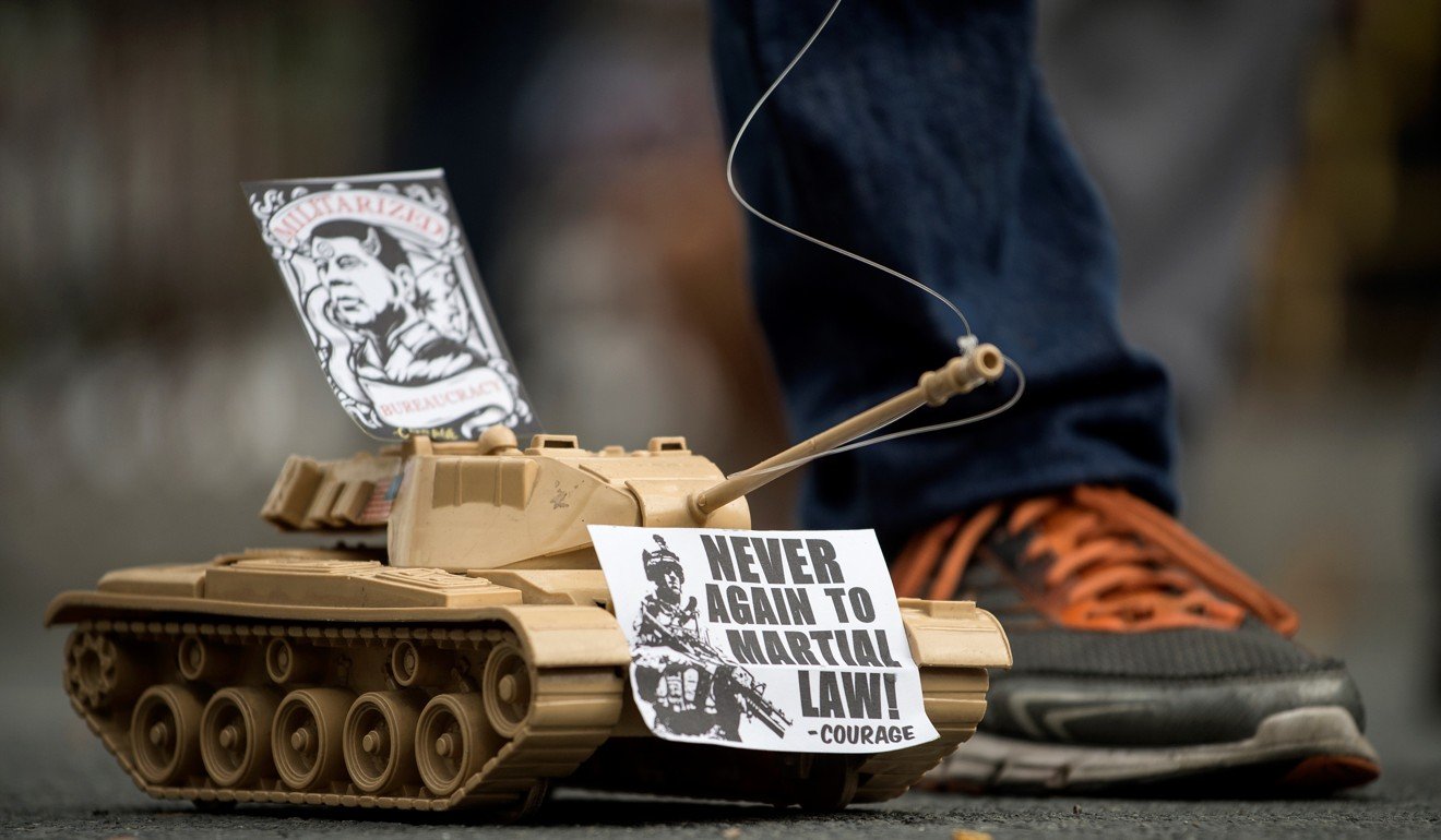 A toy tank in Manila condemns the government’s martial law implemention. Photo: AFP