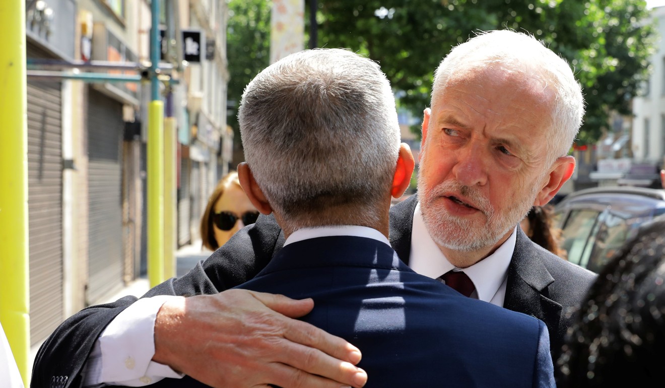 Britain's opposition Labour Party leader, Jeremy Corbyn, embraces London Mayor Sadiq Khan, before walking to the Finsbury Park Mosque. Photo: Reuters