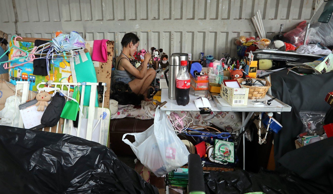 A homeless person surrounded by their belongings on a Mong Kok footbridge. The city has the world’s priciest property. Picture: Edward Wong